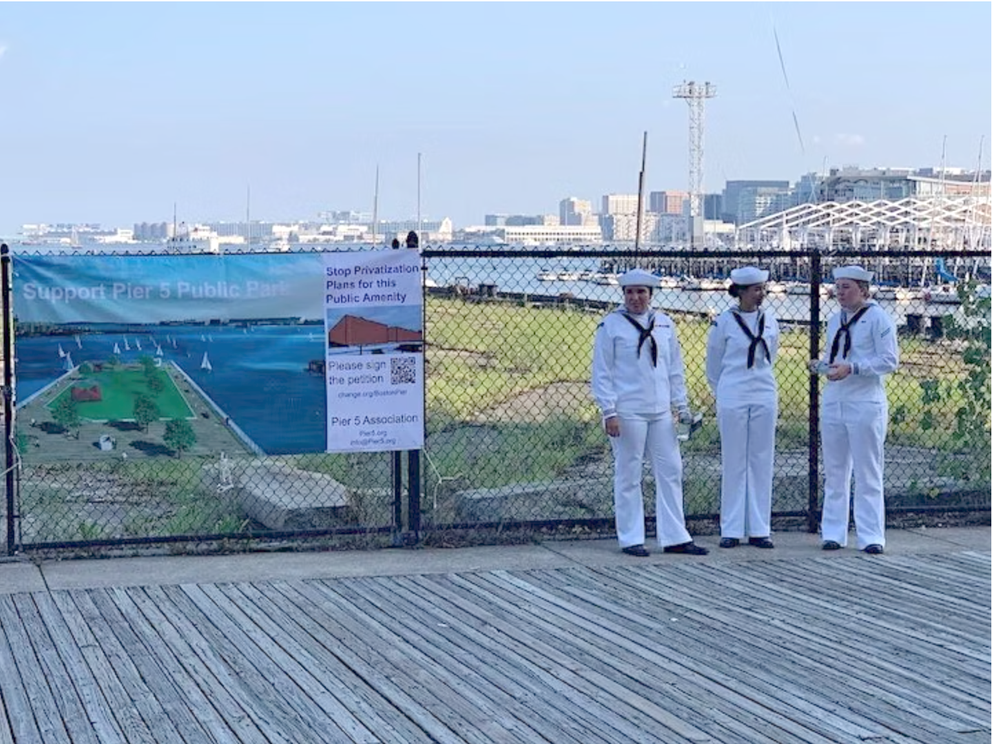 Current Women Navy Cadets stand by a Pier 5 Memorial Harbor Park.